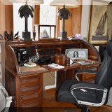F108. Antique roll top desk and desk chair.